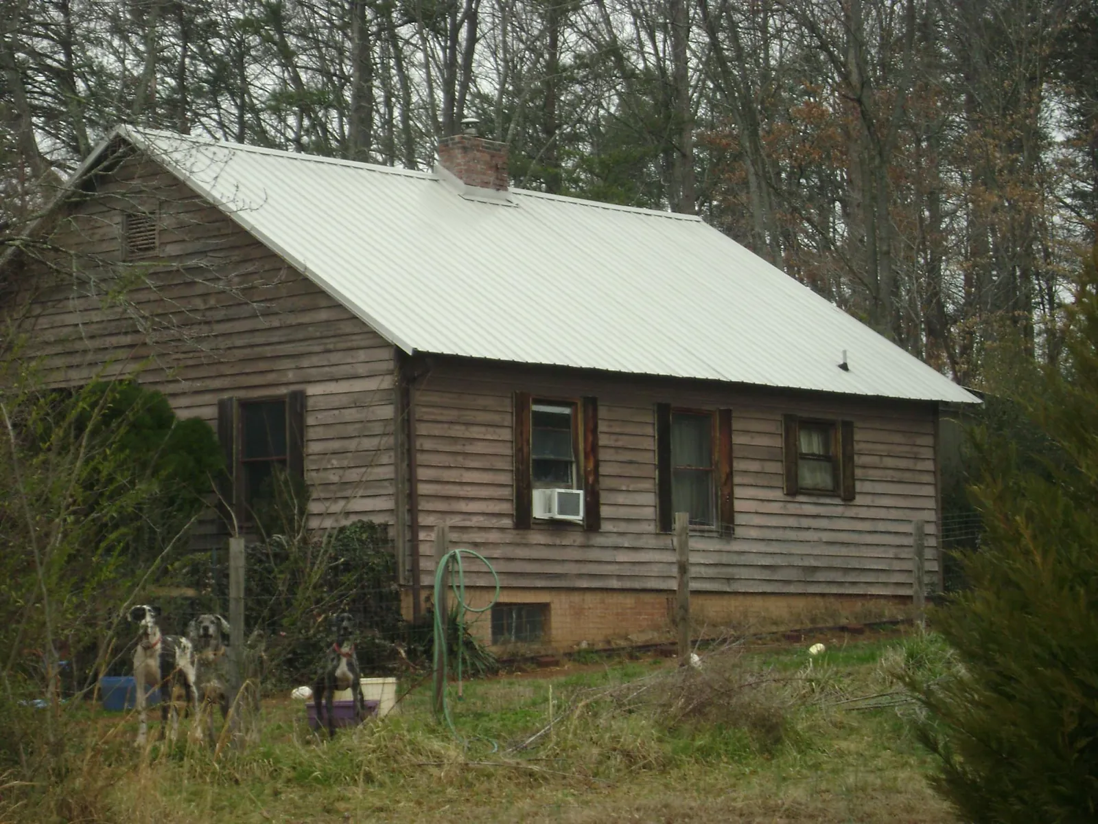 White metal roof on an old wood sided farmhouse, from a Metal Roof Installation job in Lemont
